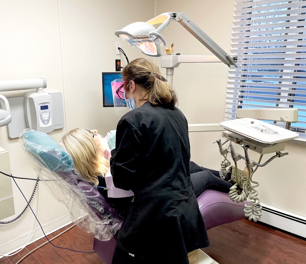 A Design That Smile team member caring for a patient in a treatment room