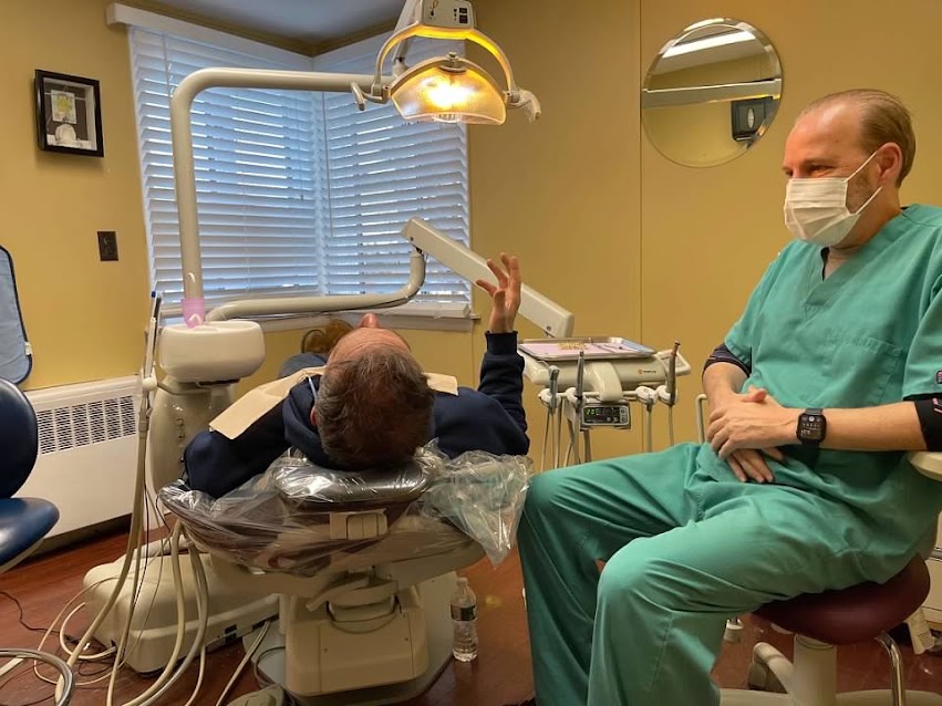 A Design That Smile staff member working with a patient in a treatment room